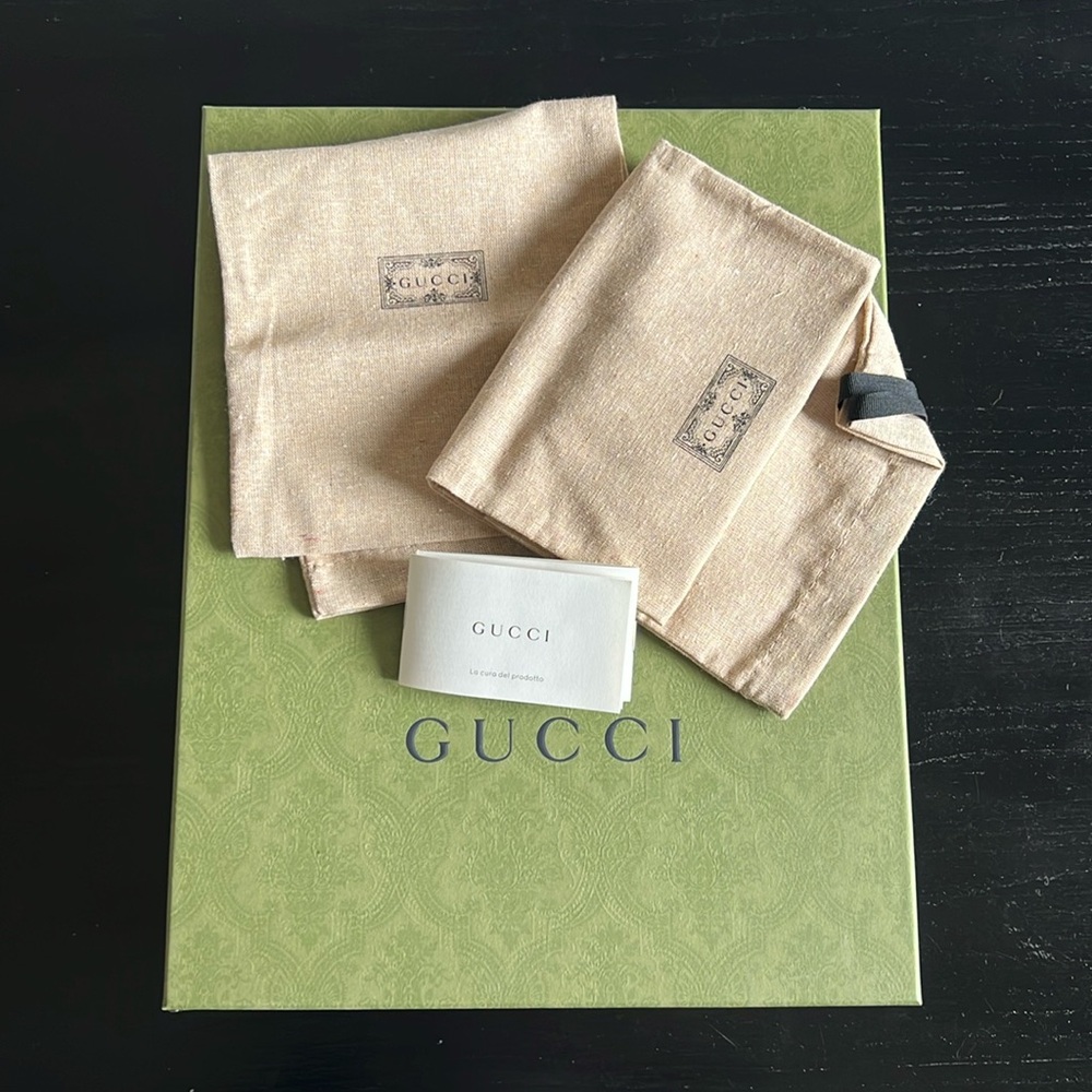 Gucci box, 2 dust bags, gucci pamphlets.